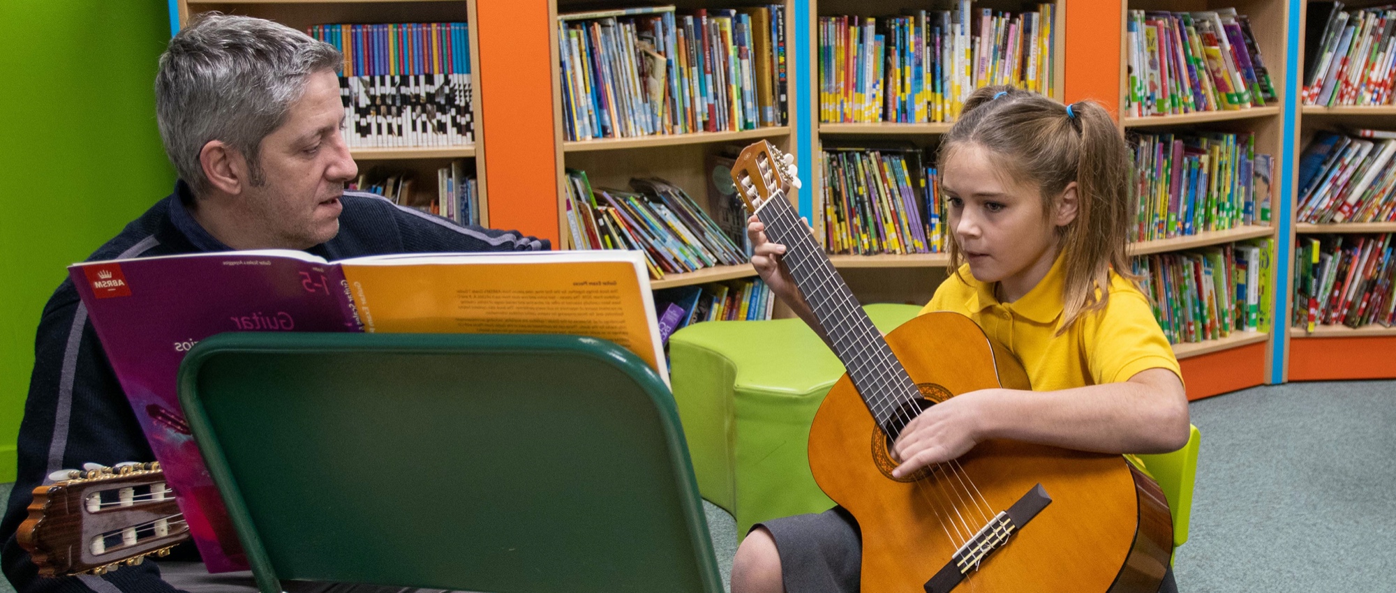 Girl learning to play the guitar